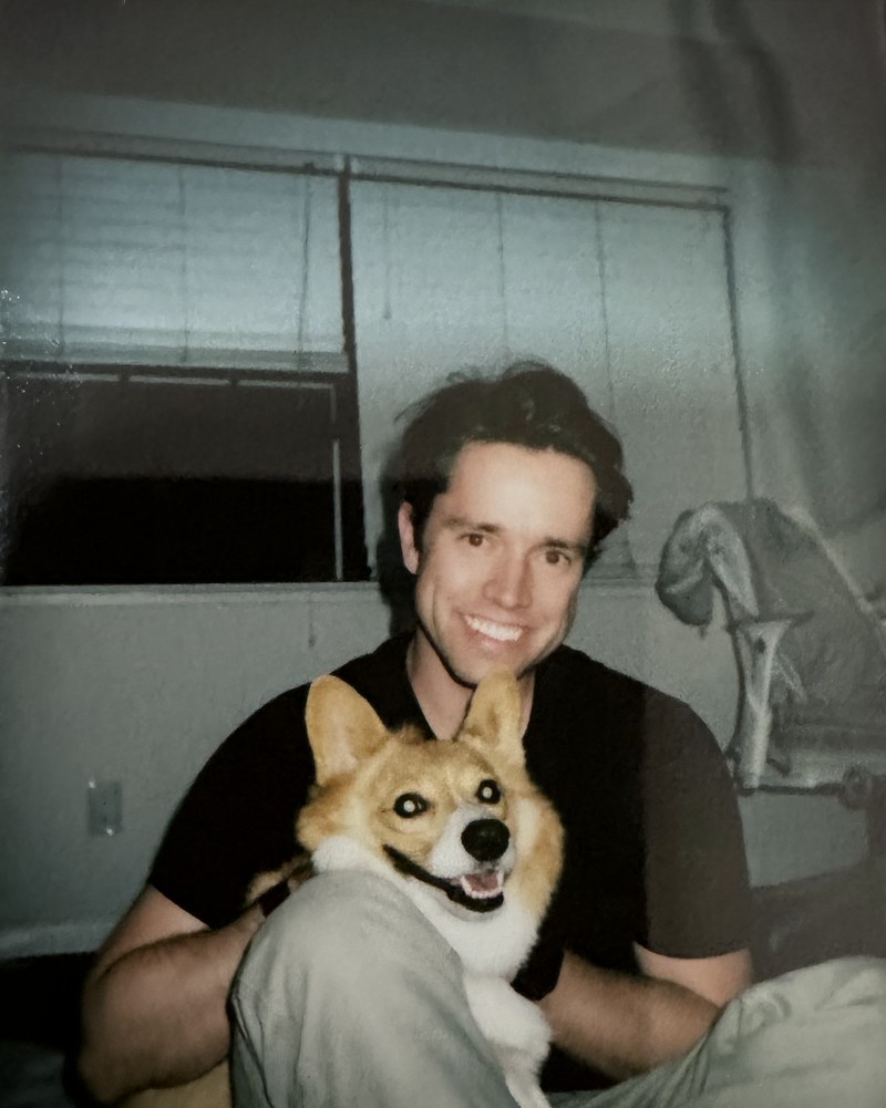 Polaroid photo of Erik MacLennan with his corgi